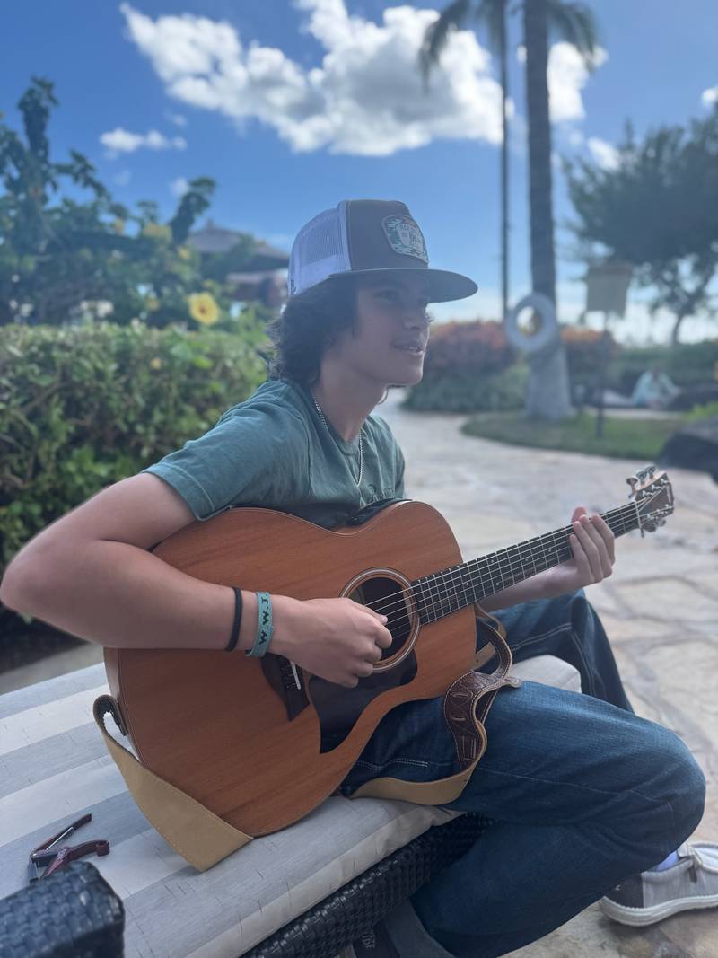 Matteo singing with his guitar